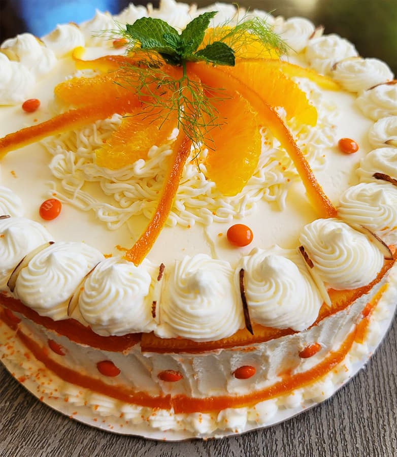 A beautifully decorated sponge cake with mandarin orange slices prepared by a Park City Culinary Institute student.